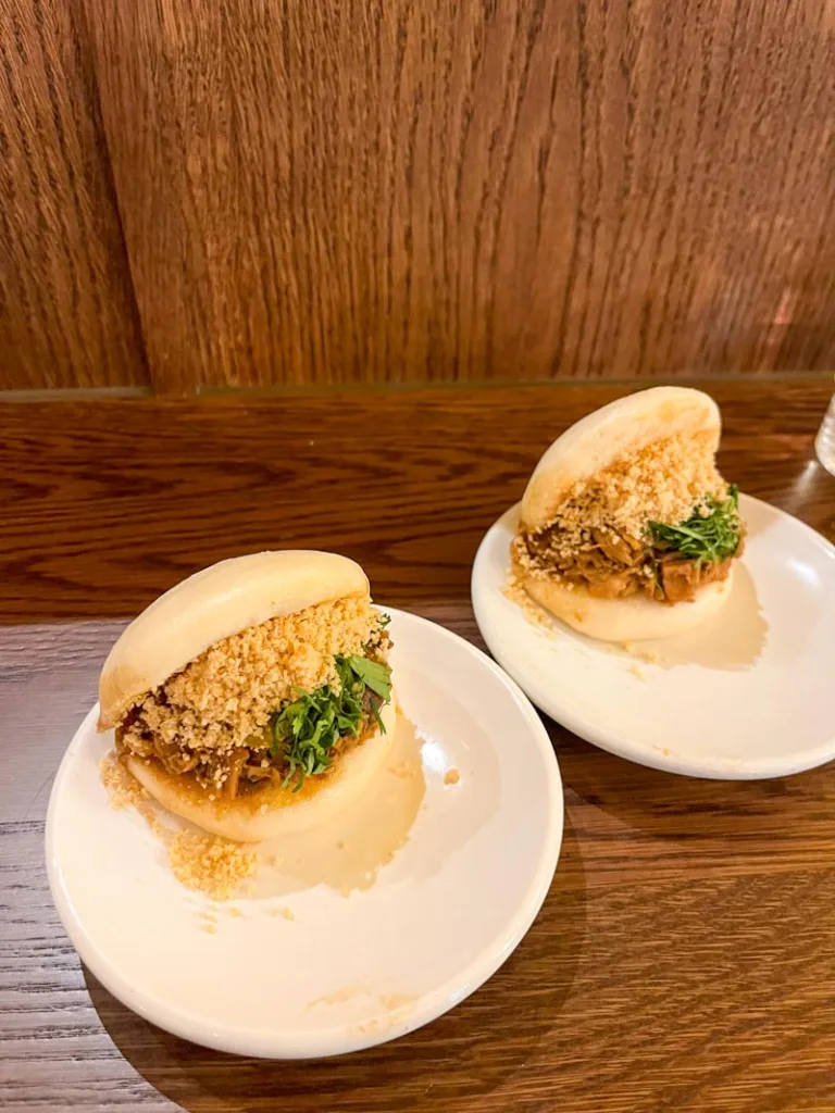 two pulled pork bao buns on a plate at bao in london