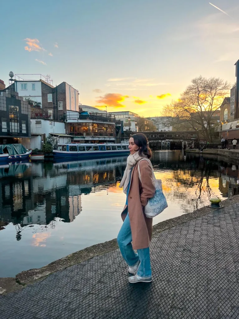 woman standing next to a picturesque canal in london