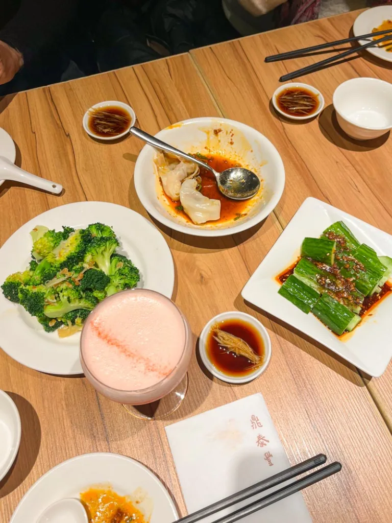 a cocktail and a spread of small dishes at din tai fung, london