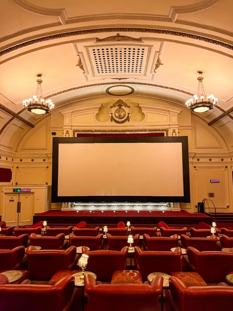 rows of red leather seats and an arched room at the electric cinema in notting hill, london