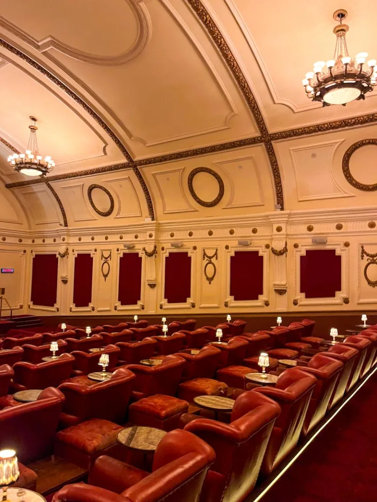 rows of red leather seats and an arched ceiling at the electric cinema in notting hill, london