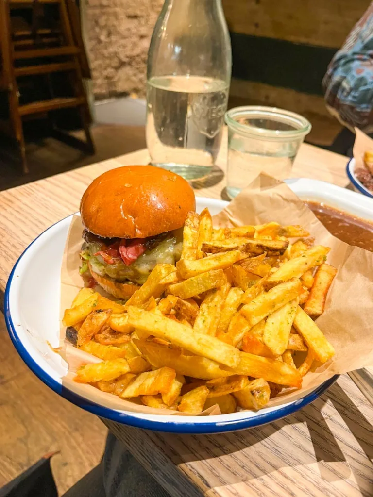 burger and a mountain of fries on a plate at honest burgers in london