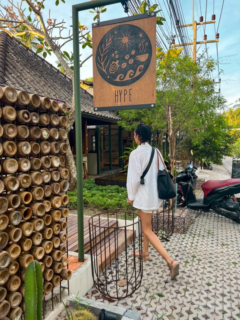 woman walking into hype coffee shop in koh tao, thailand