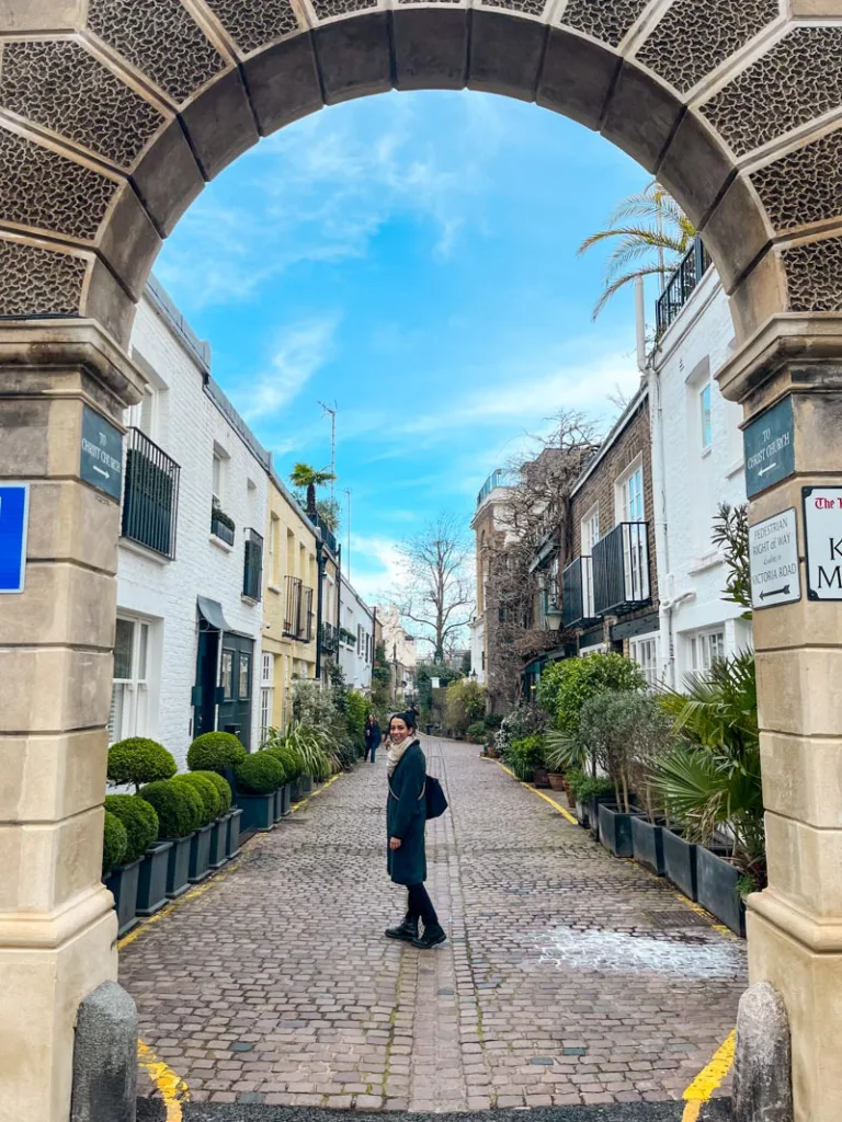 woman standing in the middle of a mew in kensington, london
