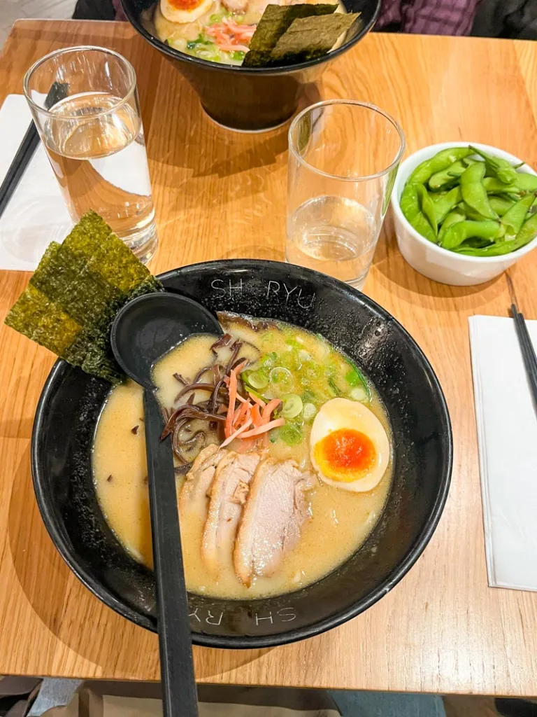 two ramen bowls and a bowl with edamame at shoryu ramen in london
