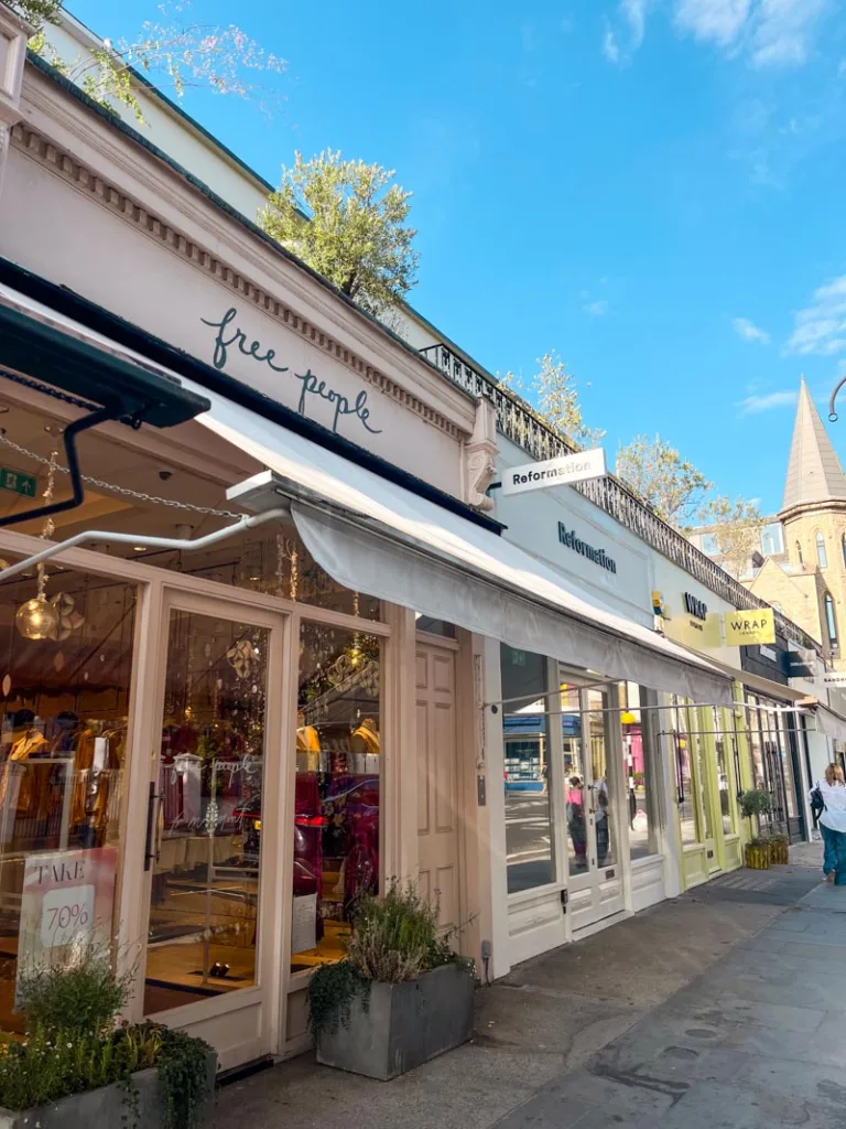 row of pastel colored shops in Westbourne Grove in notting hill, london